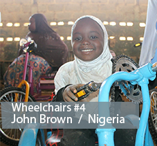 John Brown in Nigeria a girl sits in a wheelchair made with bicycle parts