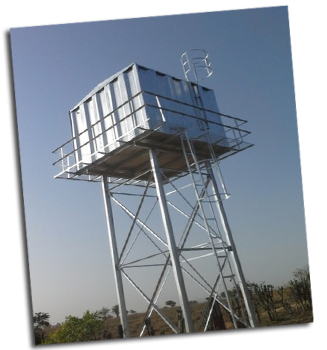 A tall water tower rises above the trees.